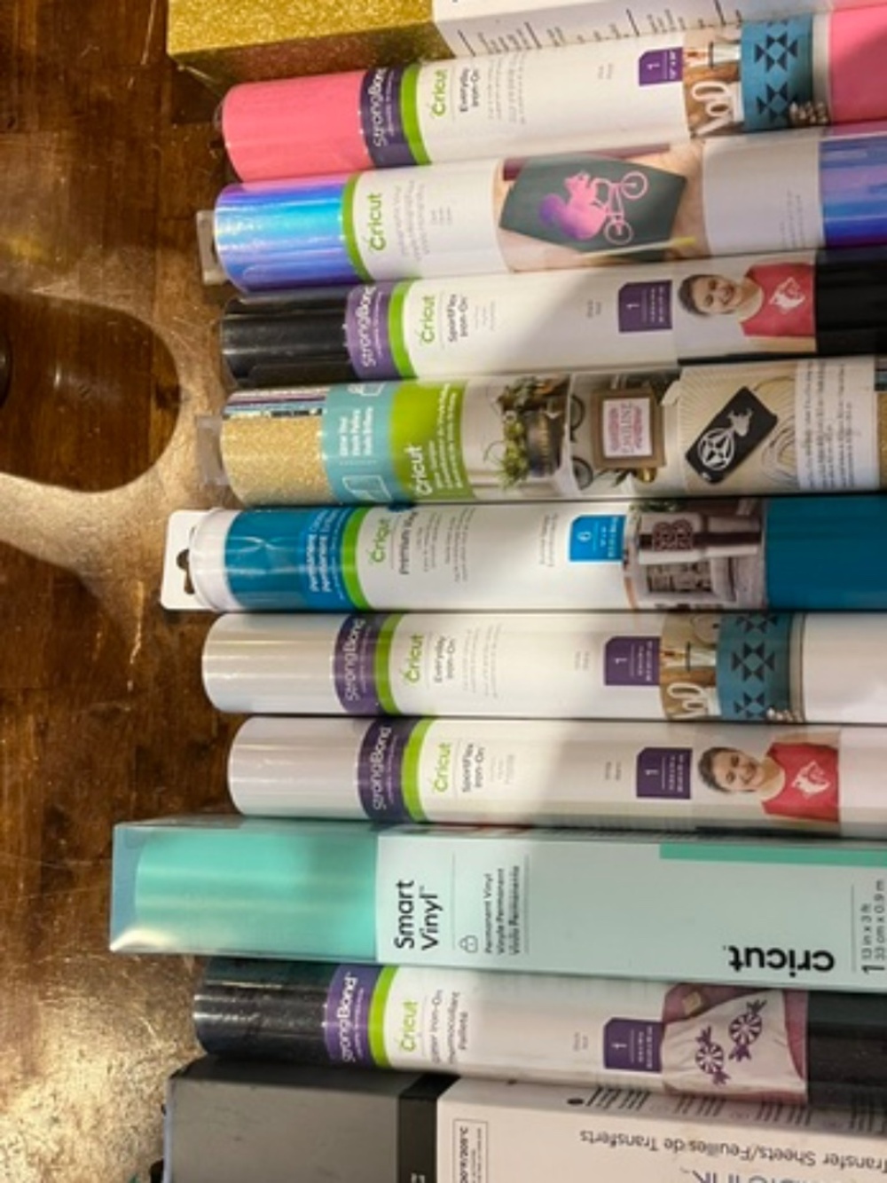 12 rolls assorted colors and styles of vinyl, etc. used in Cricut machine
